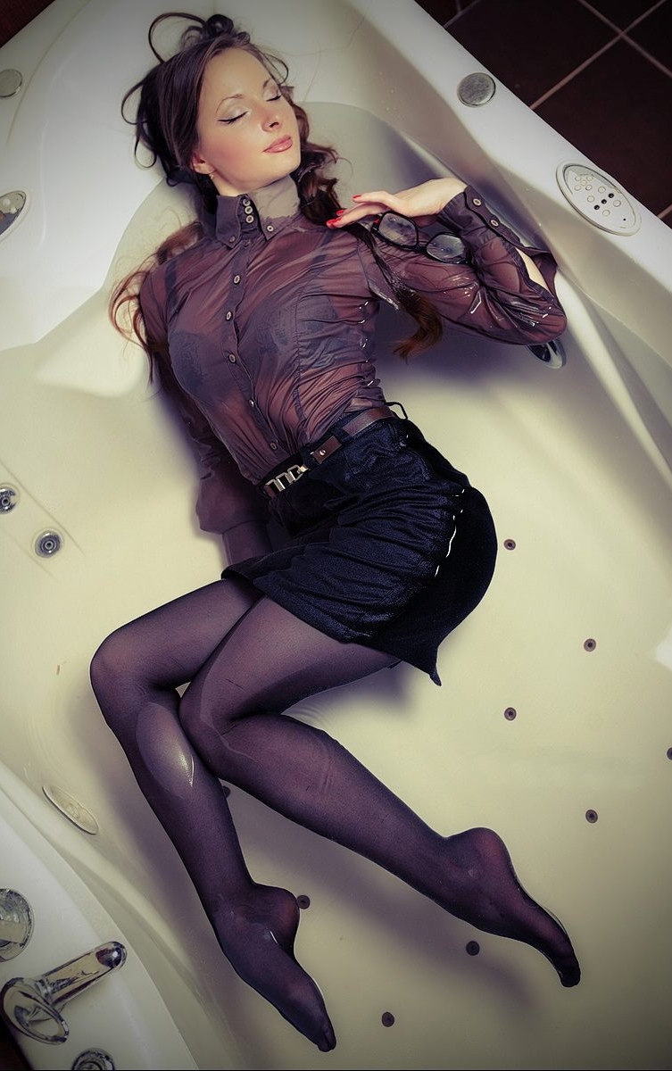 Brunette Young Woman wearing Wet Black Pantyhose and Wet See-Through Shirt